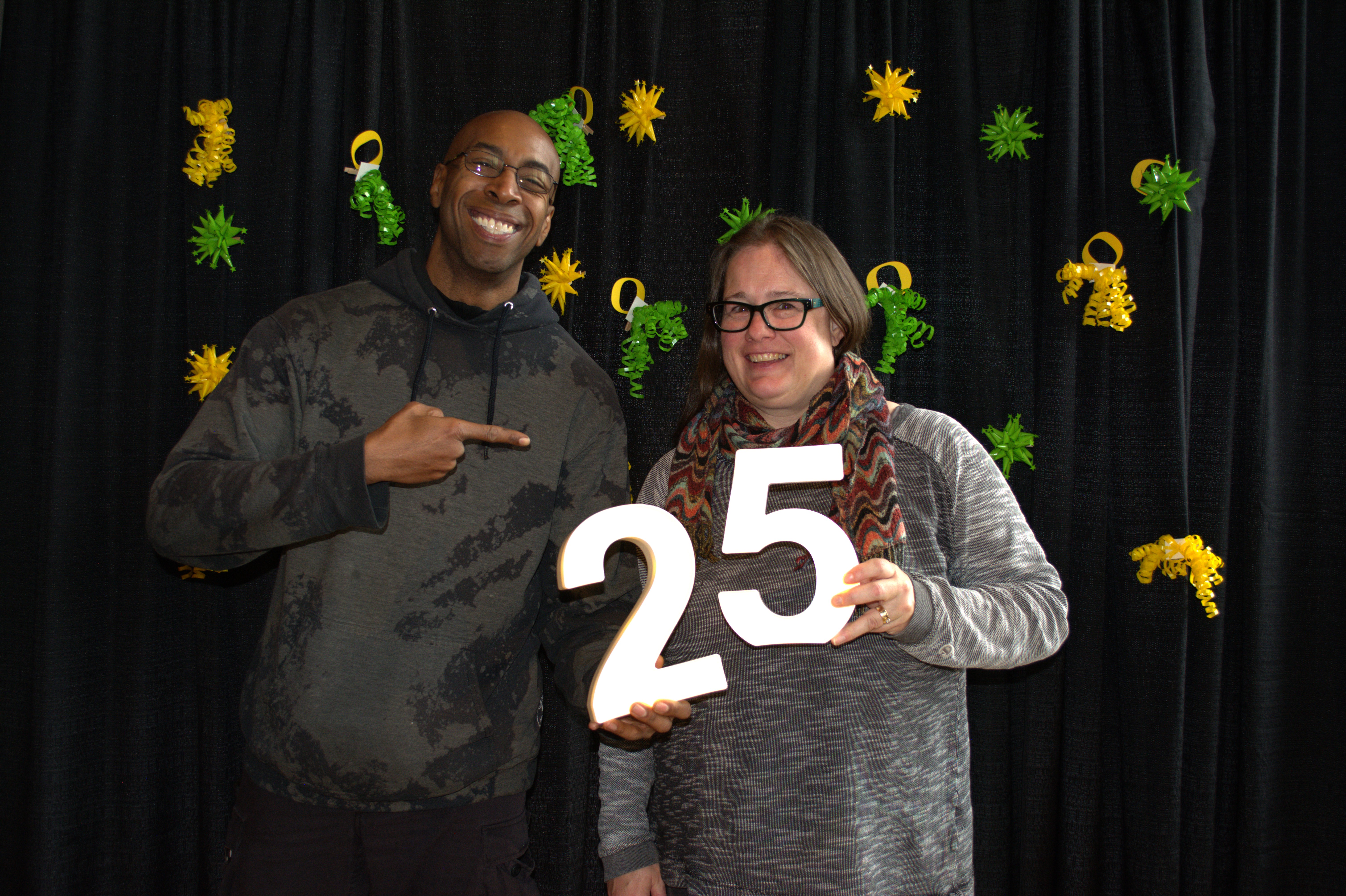 Two people celebrating someone's 25 years of service